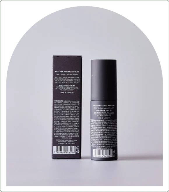 Black skincare product on grey background